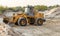 Wheel loader excavator at work. Bulldozer loading sand