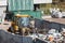 Wheel loader with lifted scrap grapple moving along a recycling center