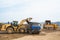 Wheel loader loads clay into the bucket of a dump truck