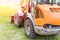 Wheel loader machine on grass field in park area. Municipal works on reconstruction and renewal city recreation area. Heavy and