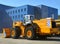 Wheel loader machine for handling bulk materials in an open pit or construction site. Heavy quarry equipment with bucket. Heavy