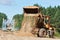 Wheel loader machine unloading sand at eathmoving works at construction site