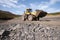 Wheel loader in a mountainous area in an industrial area where minerals are mined.