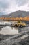 Wheel loader in a mountainous area in an industrial area where minerals are mined.