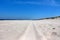 wheel marks on an empty sea beach in the first sunny days of summer, DziwnÃ³w, Poland