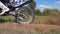 Wheel of motocross bike starting to spin and kicking up ground or dirt. Motorcycle starts the movement. Slow motion