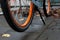 Wheel of orange bike in autumn