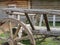 Wheel and part of the wooden waggon near windmill