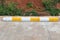 Wheel stop concrete with paint yellow and white of outdoor parking, Rubber Wheel Stopper/Parking space. yellow sign on the road of