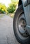 Wheel tire car on the road, against the backdrop of a dirt road