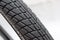 Wheel tire profile, close up. Blurry white background.