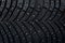 Wheel tire seamless pattern. A close up of a tire protector and studs. Winter tyre texture. Realistic illustration. Black rubber,