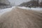 Wheel tracks on mud. Snow on dirty soil with car wheel tracks.