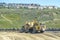 A wheel tractor scrapers excavator on a construction site