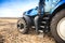 A wheel from a tractor working in the field close up. The concept of agriculture.