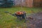 Wheelbarrow, rake and leaves