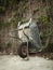 Wheelbarrow resting on a wall. Vertical.