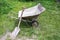 Wheelbarrow with shovel leaning at lawn
