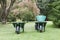 Wheelbarrows, buckets and gardening tools in mature formal garden