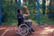 Wheelchair basketball payer dribbling ball like professional, ready to shoot and score goal.