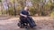 Wheelchair man. Handicapped man. young disabled man rides in an automated wheelchair and talking on a cell phone, in a