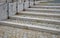 Wheelchair ramp and stairs in the park. a step with a long tread surface overcomes a small elevation. gray railings and granite re