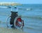 Wheelchair on the shore by the ocean on a hot sunny summer day