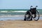 Wheelchair stands on the seashore