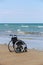 Wheelchair stands on the seashore