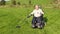 Wheelchair user metal detecting in a field