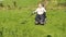 Wheelchair user metal detecting in a field