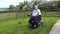 Wheelchair user metal detecting in a field