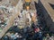 Wheeled loader operating on landfill site, carrying and dumping waste, aerial