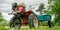 Wheeled tractor with trail in country house vegetable garden