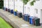 Wheelie bin colour blue, purple and black for refuge collection outside house in a row