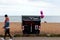 Wheelie bin with pink balloons on Brighton beach.