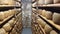 Wheels of cheese on the racks of a maturing cave