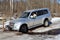 Wheels Jeep stuck in creek on ice forest road.