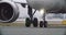 The wheels of a passenger plane drive down the airport runway after landing.