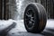 Wheels with winter tires in the snow on a background of a winter forest,