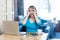 Where you? Portrait of suprised young businesswoman in blue blouse are sitting in cafe and holding her hands near eyes like making