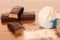 Whey protein powder in measuring scoop and chocolate protein bar