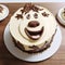 Whimsical Animal Face Cake: Playful Cartooning In Light Yellow And Brown