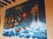 Whimsical book themed mural of flying ship in night sky with clouds hot air balloon castle and books