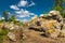 Whimsical boulders under a blue sky with clouds