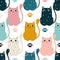 Whimsical bright cats with big eyes create a cute seamless pattern for modern fabrics