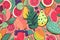 Whimsical and colorful seamless pattern featuring a variety of tropical fruits such as pineapple, watermelon, and papaya