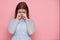 Whimsical crying beautiful woman isolated on pink background.