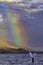 Whimsical humpback whale tail against a beautiful rainbow backdrop.