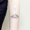 Whimsical Minimalism: Mountain And Moon Tattoo On Forearm